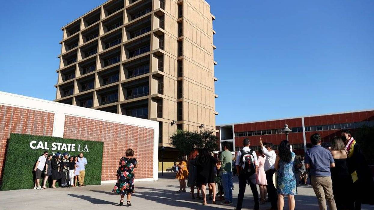 Cal State Los Angeles graduates and loved ones line up to take photos following their commencement ceremony which was held outdoors beneath a tent on campus on July 27, 2021 in Los Angeles, California.