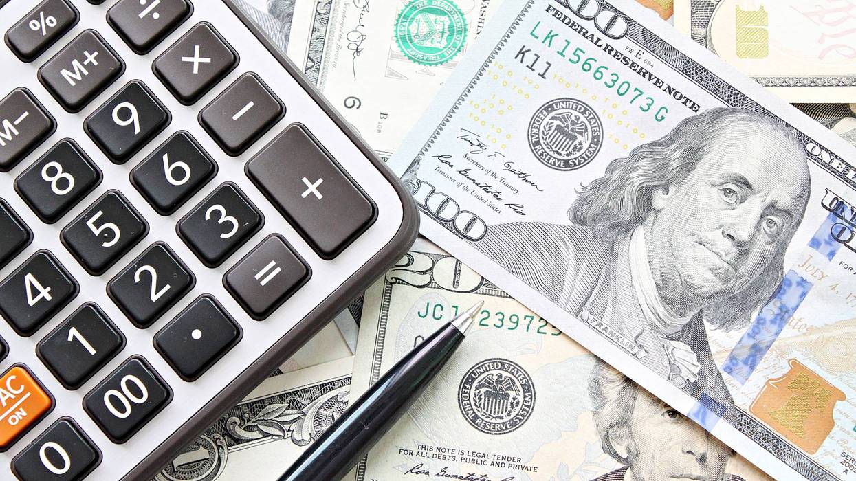Calculator, pen lay on money