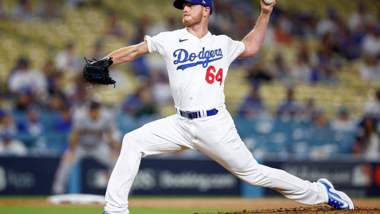 Caleb Ferguson #64 of the Los Angeles Dodgers pitches in the ninth inning against the Arizona Diamondbacks during Game One of the Division Series at Dodger Stadium on October 07, 2023 in Los Angeles, California.