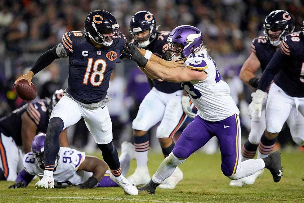 Caleb Williams #18 of the Chicago Bears stiff arms Andrew Van Ginkel #43 of the Minnesota Vikings during the game at Soldier Field on September 08, 2025 in Chicago, Illinois.
