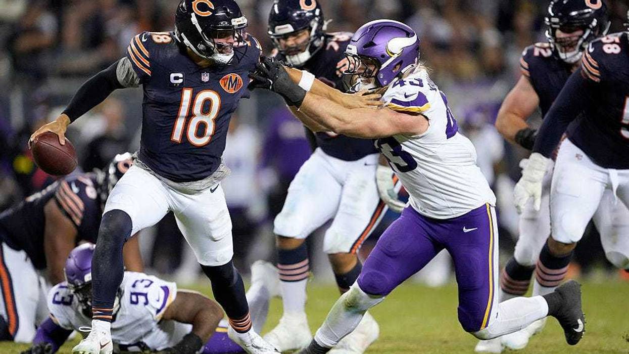Caleb Williams #18 of the Chicago Bears stiff arms Andrew Van Ginkel #43 of the Minnesota Vikings during the game at Soldier Field on September 08, 2025 in Chicago, Illinois.