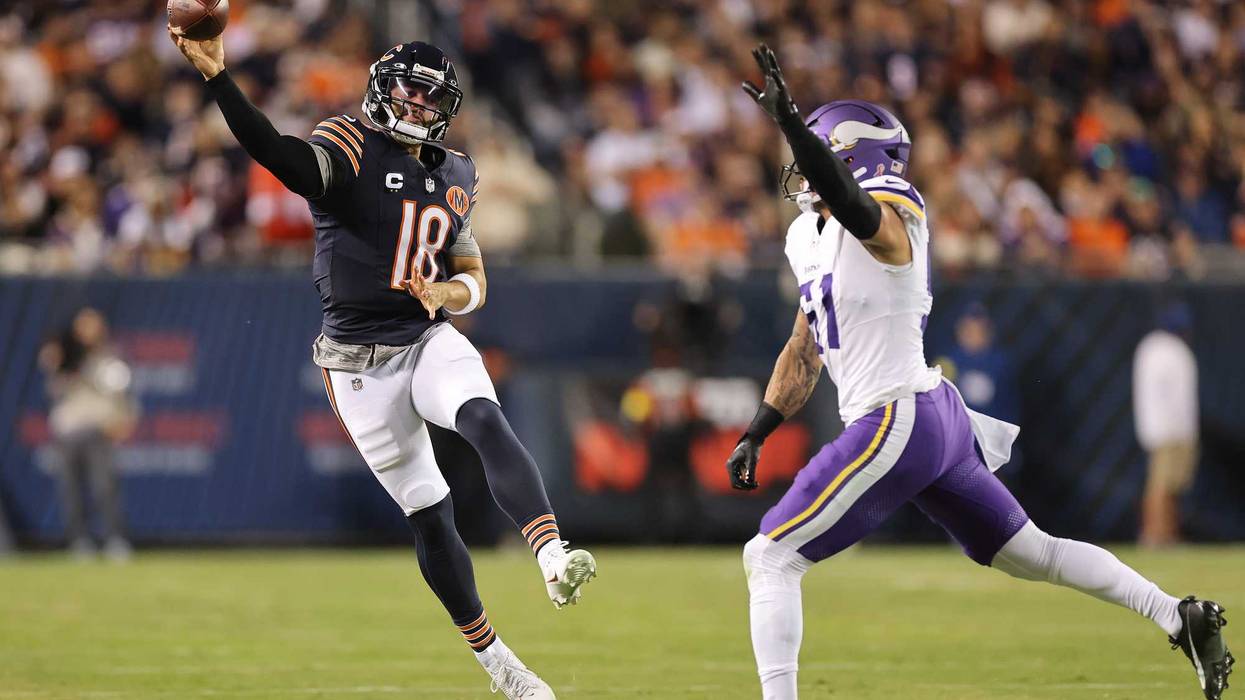 Caleb Williams #18 of the Chicago Bears throws a pass around Blake Cashman #51 of the Minnesota Vikings during the first quarter at Soldier Field on September 08, 2025 in Chicago, Illinois.