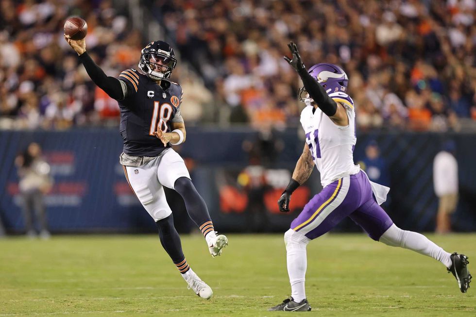 Caleb Williams #18 of the Chicago Bears throws a pass around Blake Cashman #51 of the Minnesota Vikings during the first quarter at Soldier Field on September 08, 2025 in Chicago, Illinois.