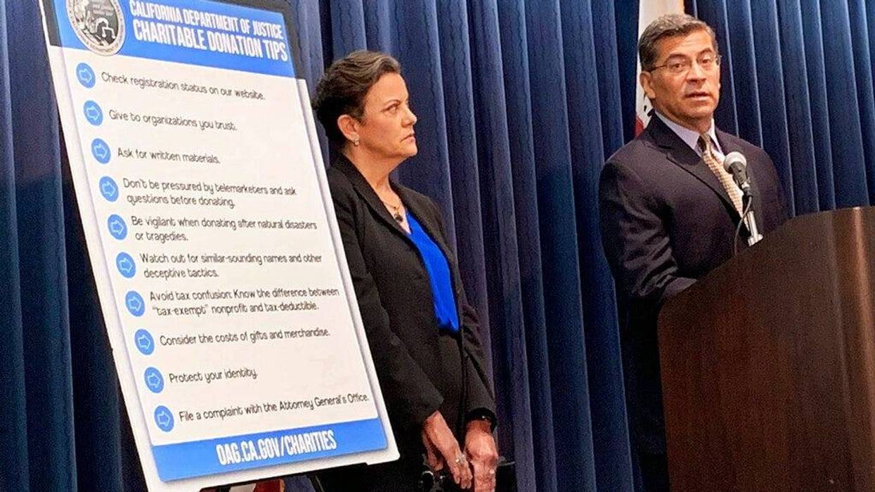 California Attorney General Xavier Becerra, right, and senior Assistant Attorney Genera Tania Ibanez announce a lawsuit the state has filed alleging misdeeds by Move America Forward