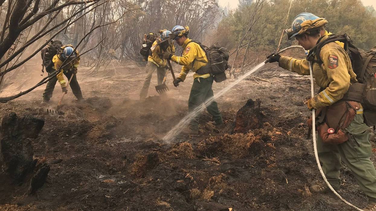 California Conservation Corps members from the Magalia Fire Camp on Thursday, Aug. 5, 2021, extinguish hot spots from the Dixie Fire that burned around Chester on Wednesday.