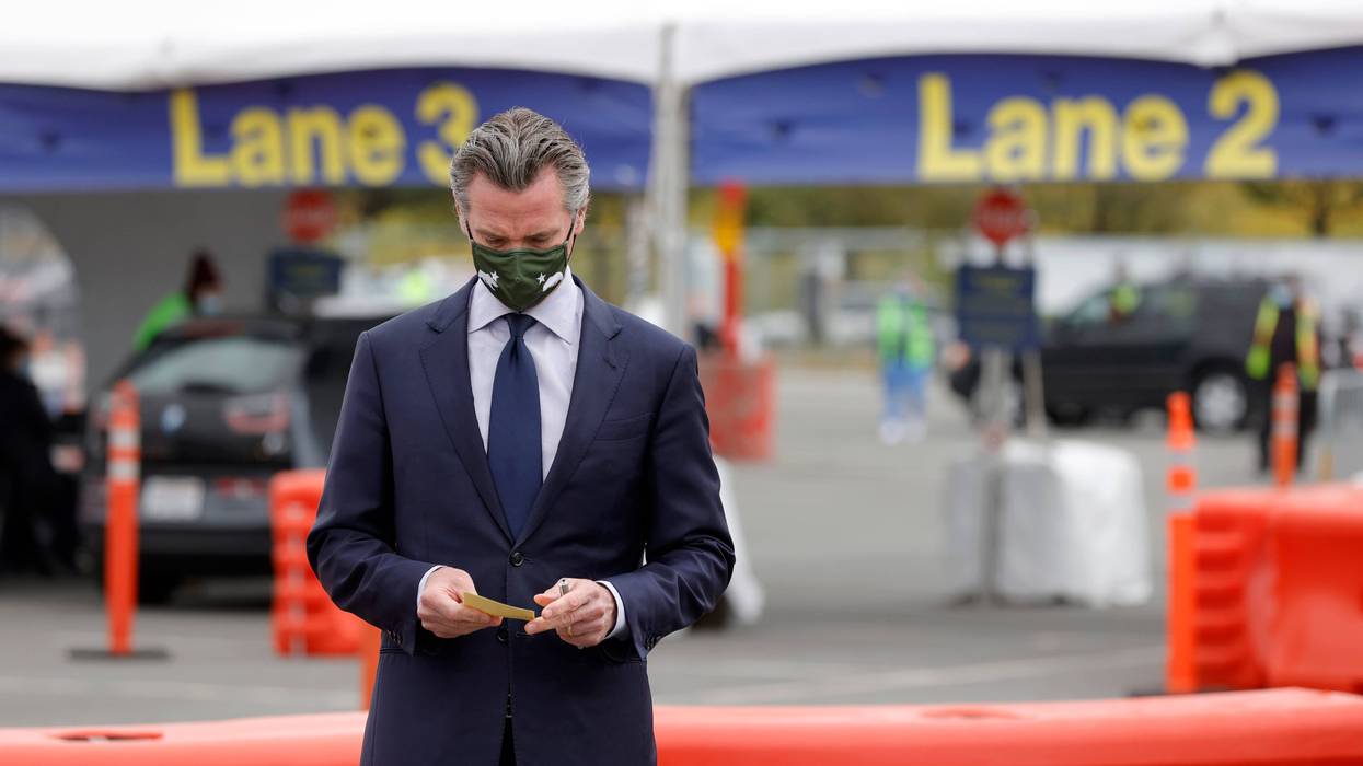 California Gov. Gavin Newsom looks at his notes before speaking at a news conference at the vaccination clinic at City College of San Francisco on April 06, 2021 in San Francisco, California.