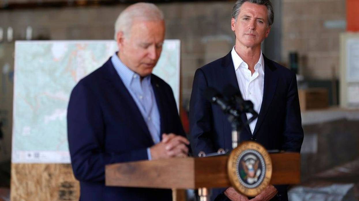 California Gov. Gavin Newsom (R) looks on as U.S. President Joe Biden delivers remarks to reporters after doing a helicopter tour of the Caldor Fire, at Mather Airport on September 13, 2021 in Mather, California.