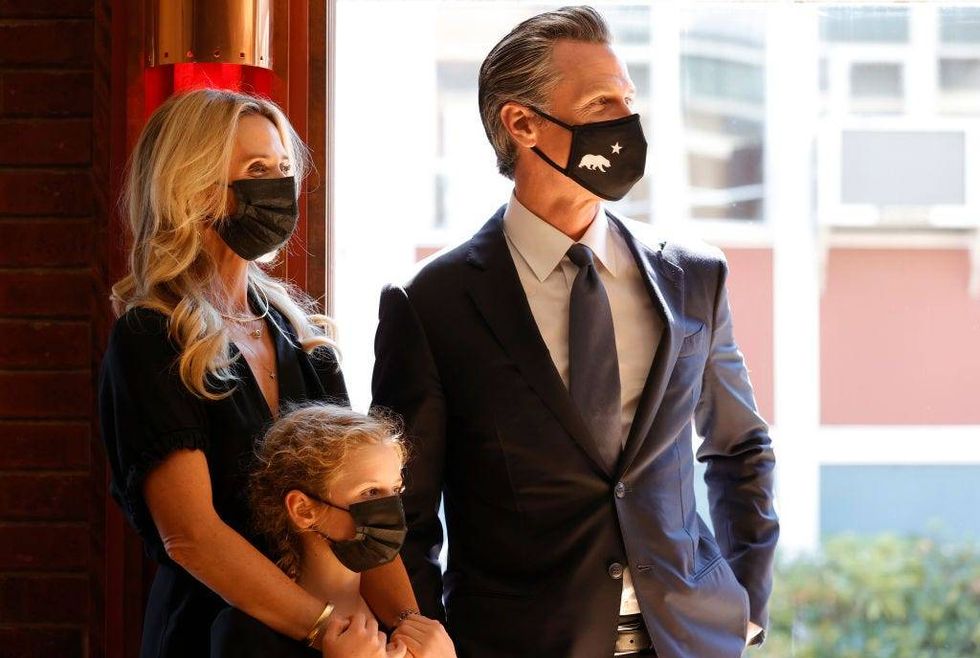 California Gov. Gavin Newsom (R) stands with First Partner Jennifer Siebel Newsom (L) and daughter Brooklynn Siebel Newsom (C) before speaking to union workers and volunteers on election day at the IBEW Local 6 union hall on September 14, 2021 in San Francisco, California.