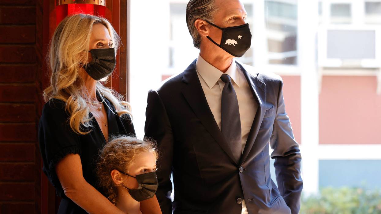 California Gov. Gavin Newsom (R) stands with First Partner Jennifer Siebel Newsom (L) and daughter Brooklynn Siebel Newsom (C) before speaking to union workers and volunteers on election day at the IBEW Local 6 union hall on September 14, 2021 in San Francisco, California.