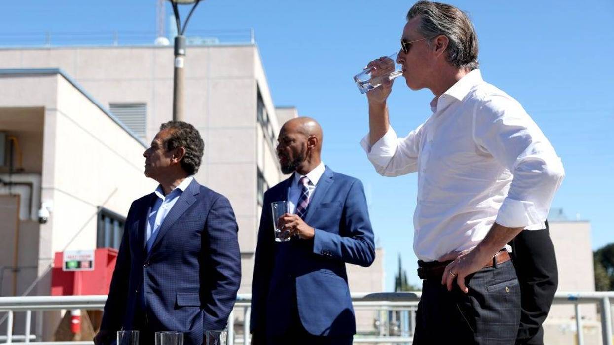 California Gov. Gavin Newsom (R) tastes recycled water that was treated at the Antioch Water Treatment Plant with Antioch Mayor Lamar Thorpe (C) and former Los Angeles Mayor and newly appointed California infrastructure czar Antonio Villaraigosa on August 11, 2022 in Antioch, California.