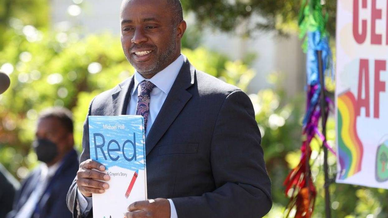 California State Superintendent of Schools Tony Thurmond holds the book "Red: A Crayon's Story" during a news conference at Nystrom Elementary School on May 17, 2022 in Richmond, California