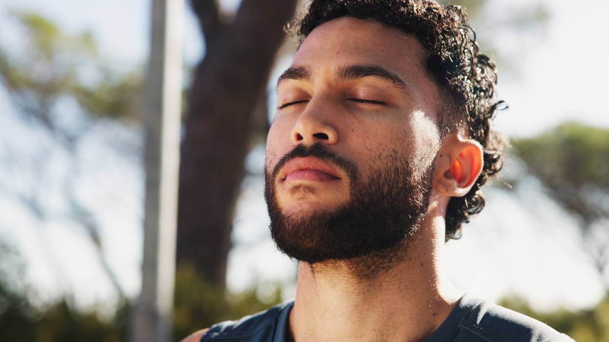 Calm man, breathing and fitness with mindfulness in nature for zen, workout or exercise at outdoor park. Face, male person or eyes closed with peace or spiritual technique for health, rest or break