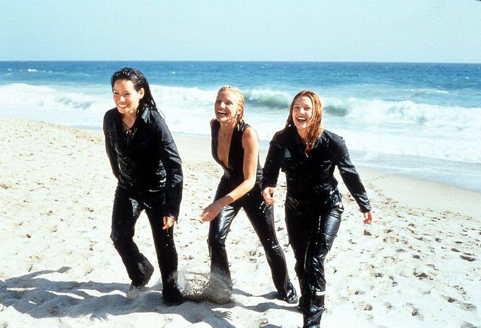 Cameron Diaz, Drew Barrymore and Lucy Liu walking up the sand of a beach in a scene from the film