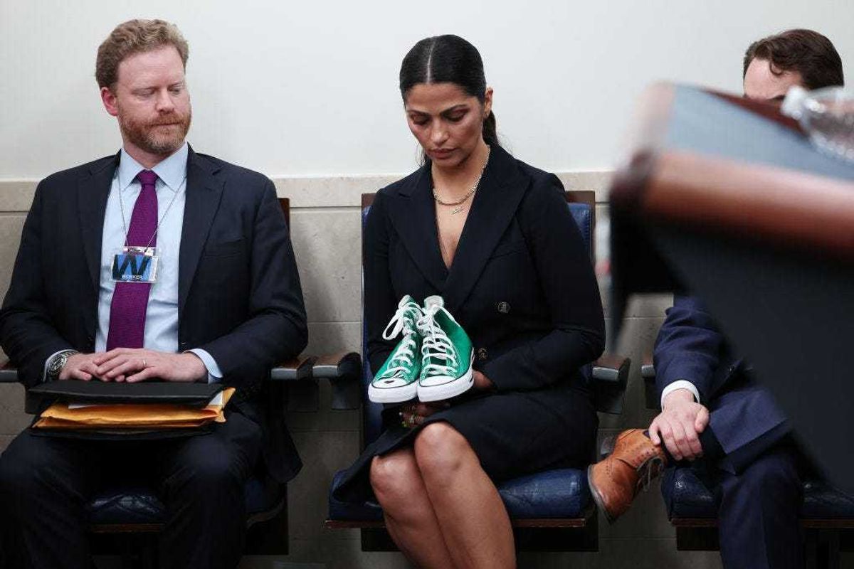 Camila Alves McConaughey, wife of actor Matthew McConaughey, holds a pair of shoes worn by one of the victims of the school shooting in Uvalde, Texas.
