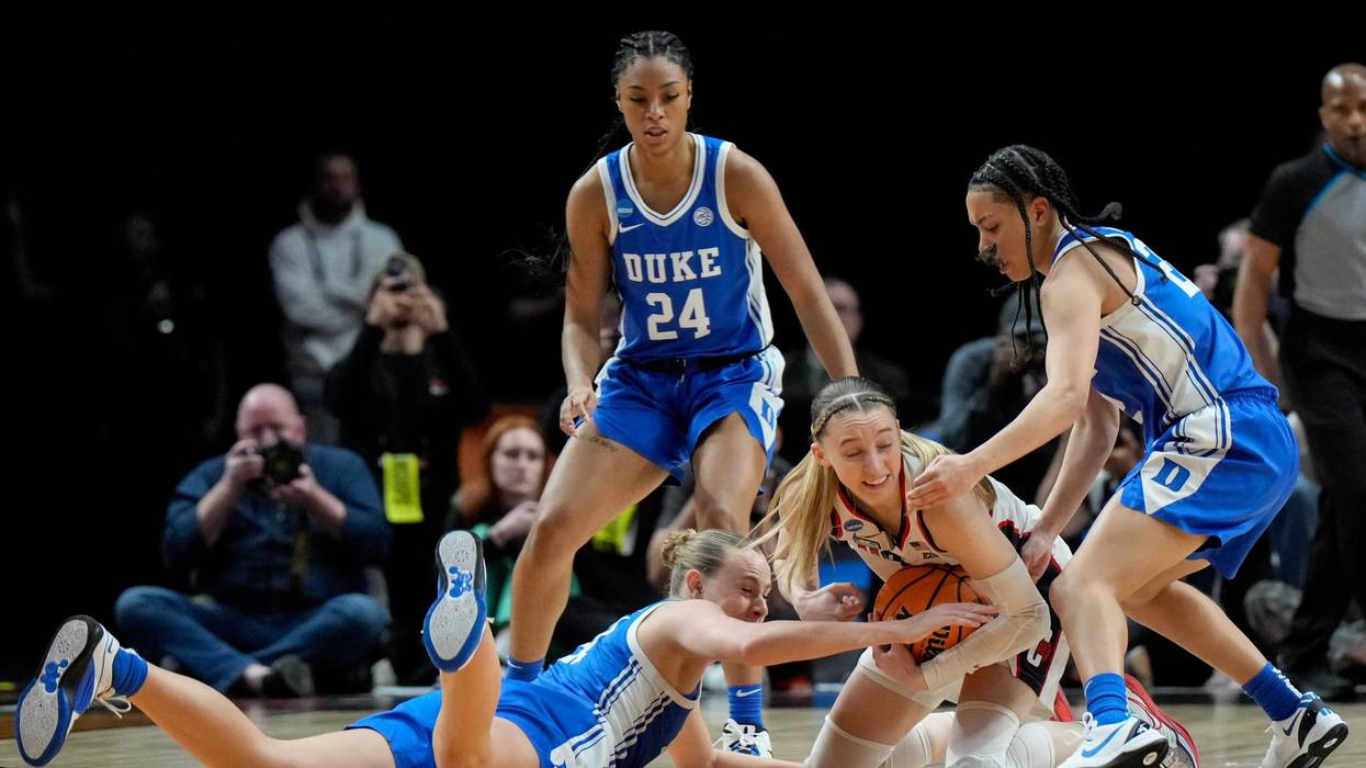 Camilla Emsbo #21 and Taina Mair #22 of the Duke Blue Devils attempt to steal the ball from Paige Bueckers #5 of the Connecticut Huskies during the second half in the Sweet 16 round of the NCAA Women's Basketball Tournament at Moda Center on March 30, 2024 in Portland, Oregon.