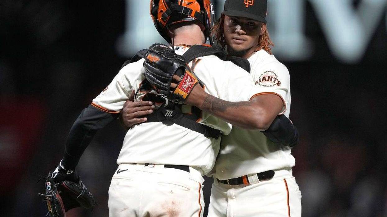 Camilo Doval #75 and Buster Posey #28 of the San Francisco Giants celebrate after defeating the Arizona Diamondbacks 1-0 at Oracle Park on September 29, 2021 in San Francisco, California.