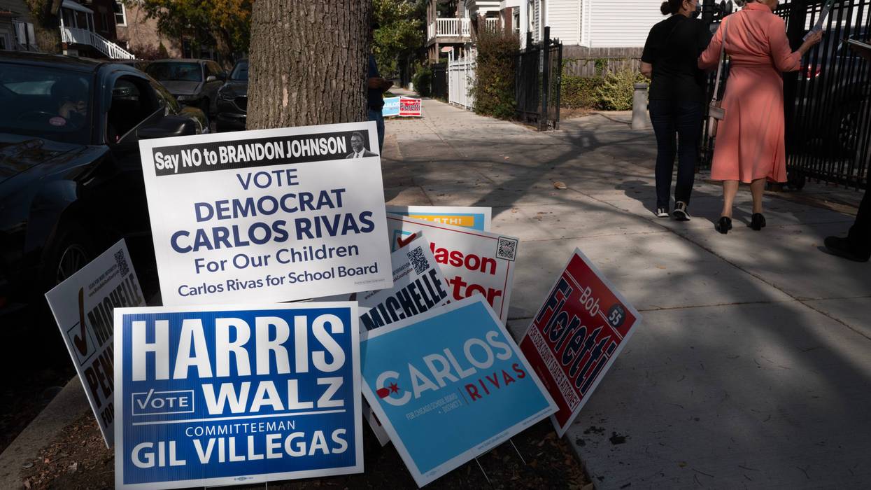 Campaign signs are posted near an early-voting location in the Humboldt Park neighborhood on Oct. 29, 2024.