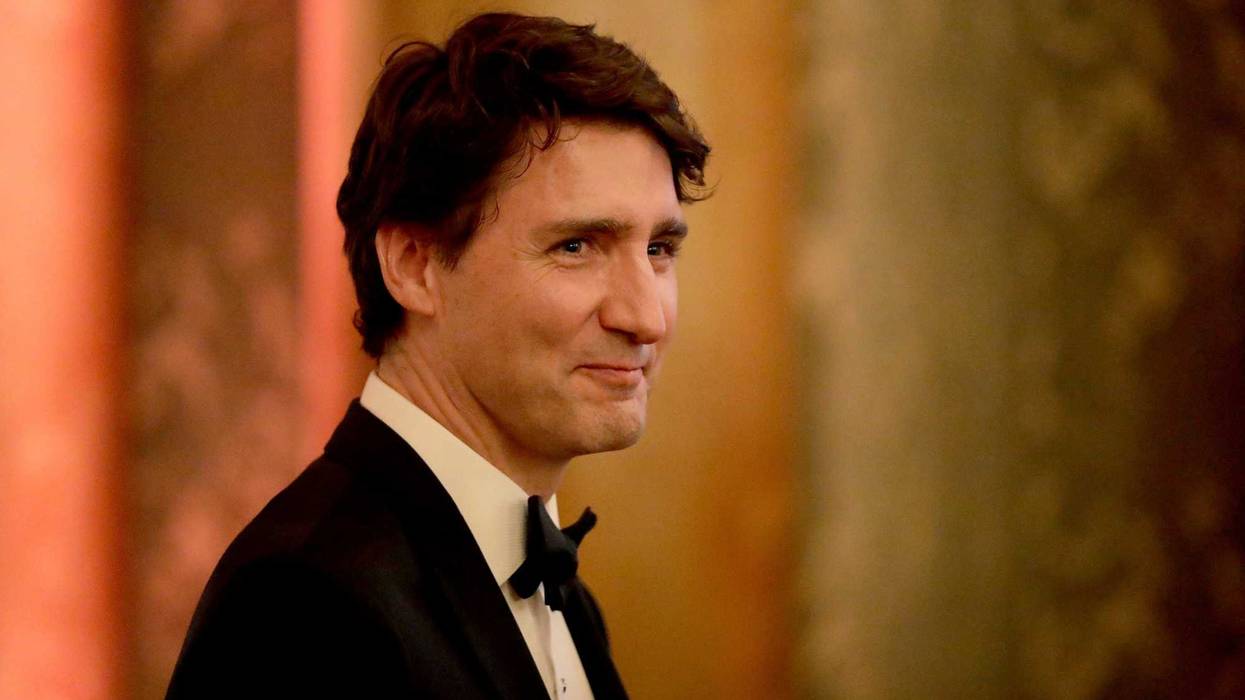 Canada's Prime Minister Justin Trudeau smiles after speaking to Queen Elizabeth II and the Prince of Wales at Buckingham Palace.