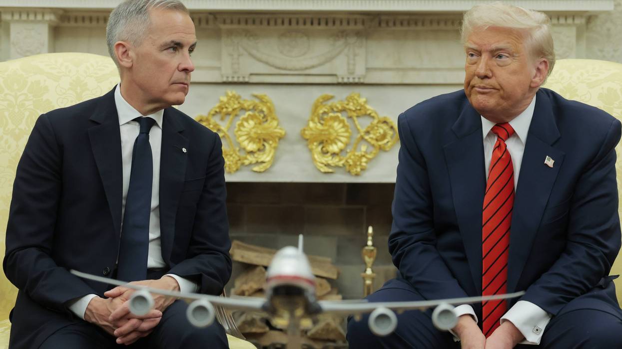 Canadian Prime Minister Mark Carney listens as U.S. President Donald Trump speaks to reporters in the Oval Office at the White House on May 6, 2025 in Washington, DC.