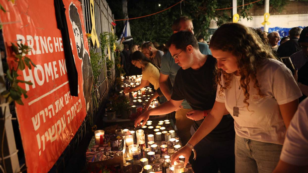 Candles are lit at a vigil for Hersh Goldberg-Polin, a young Israeli American man who was taken hostage by Hamas on Oct. 7, 2023. His body was among those of six hostages recovered over the weekend in Gaza.