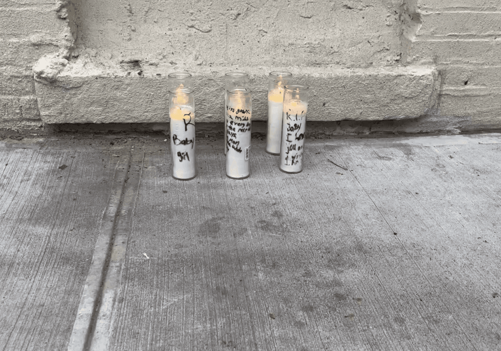 Candles were placed near the school on Tuesday at a makeshift memorial