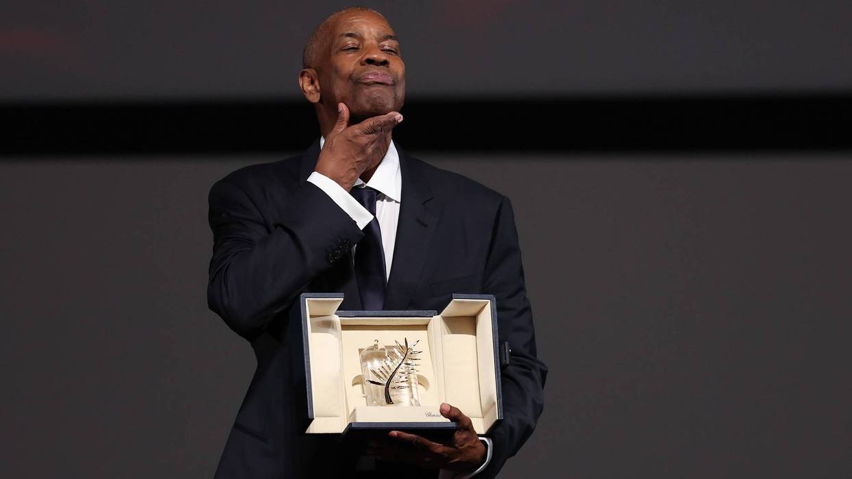 CANNES, FRANCE - MAY 19: Denzel Washington poses after receiveing an honorary Palme d'Or following a screening for the "Highest 2 Lowest" at the 78th annual Cannes Film Festival at Palais des Festivals on May 19, 2025 in Cannes, France. (Photo by Sameer Al-Doumy/Pool/Getty Images)