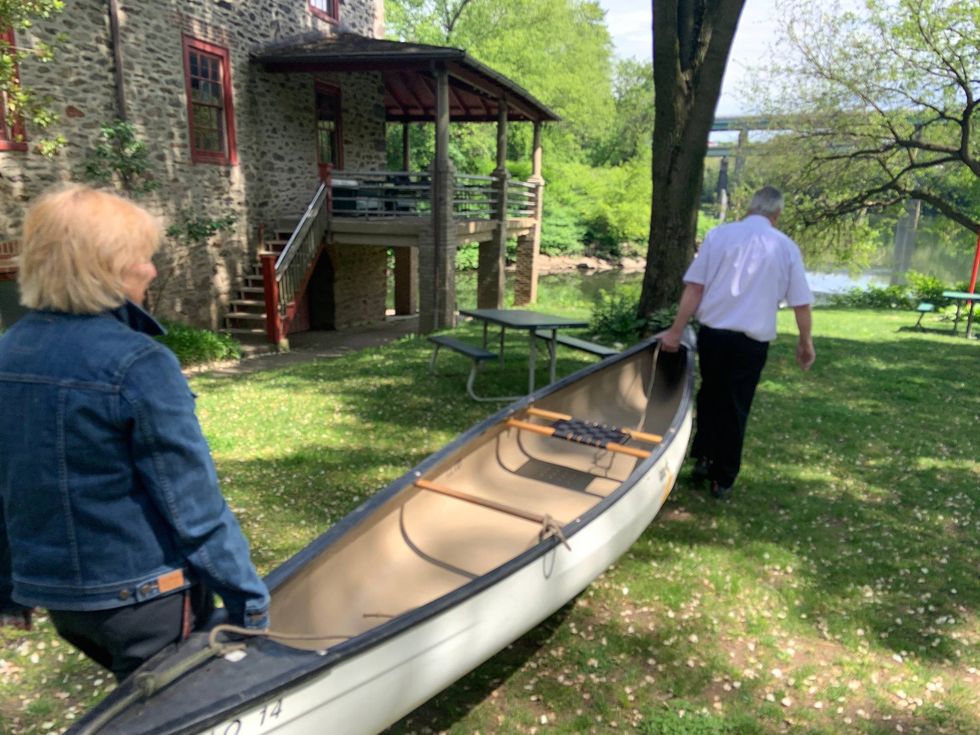 Canoe Club members carry a canoe to the river