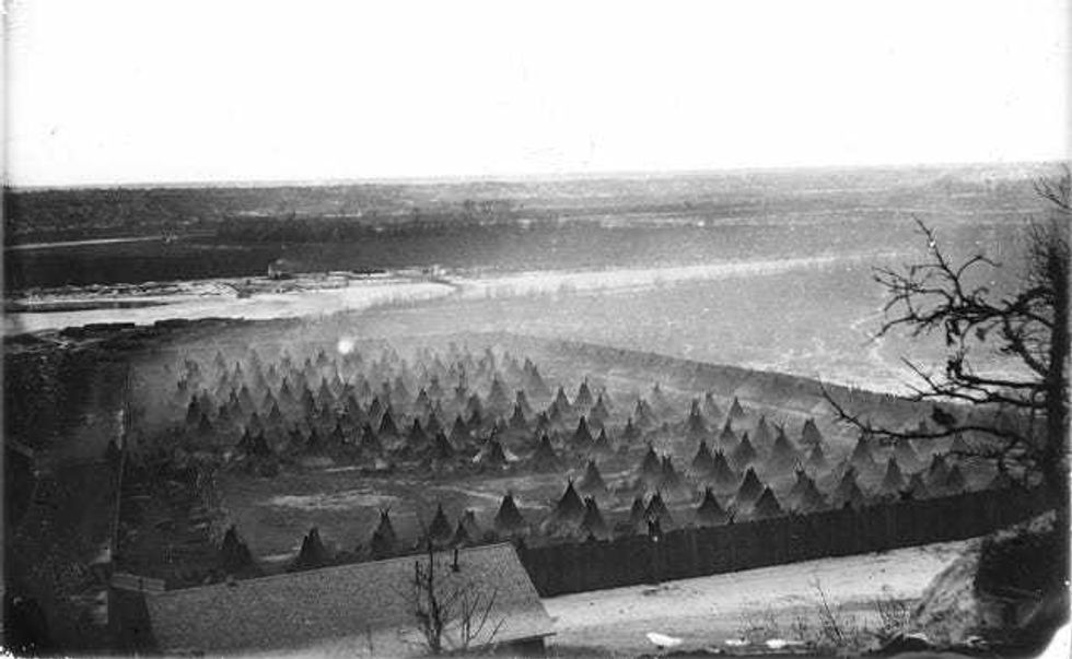 Captured Sioux Indians in fenced enclosure on Minnesota River below Fort Snelling in 1862 or 1863.