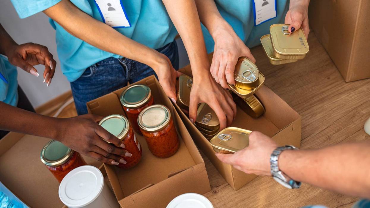 Cardboard boxes being filled with food donations
