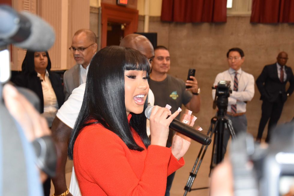Cardi B speaking at her old middle school