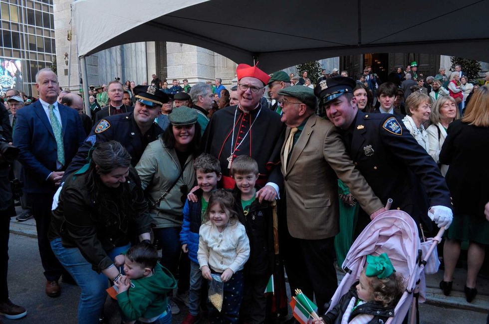 Cardinal Timothy Dolan takes a photo at the New York City St. Patrick