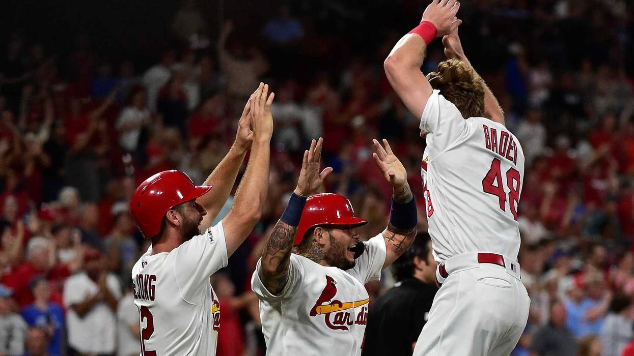 Cardinals center fielder Harrison Bader (48) celebrates with catcher Yadier Molina (4) and shortstop Paul DeJong (12).