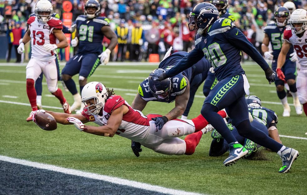 Cardinals wideout Larry Fitzgerald lunges for the end zone