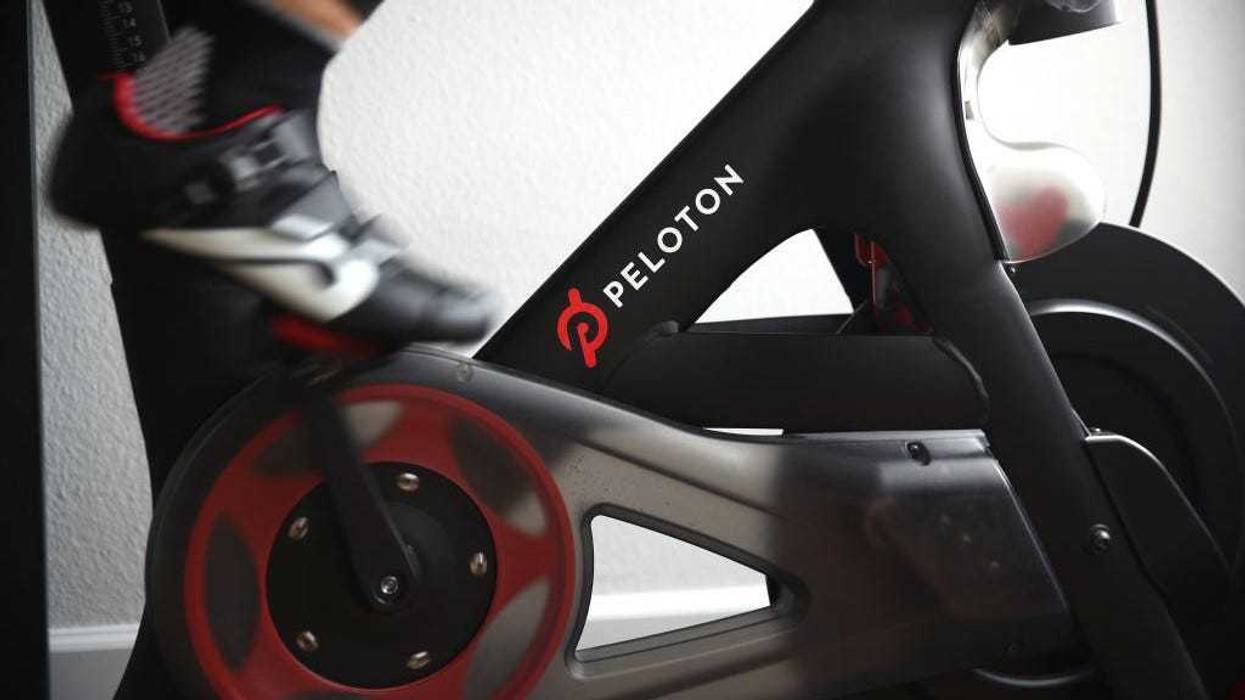 Cari Gundee rides her Peloton exercise bike at her home on April 06, 2020 in San Anselmo, California.