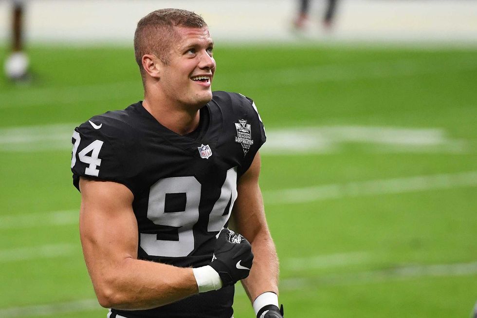 Carl Nassib #94 of the Las Vegas Raiders flexes while smiling during warmups before a game against the Denver Broncos at Allegiant Stadium on November 15, 2020 in Las Vegas, Nevada.