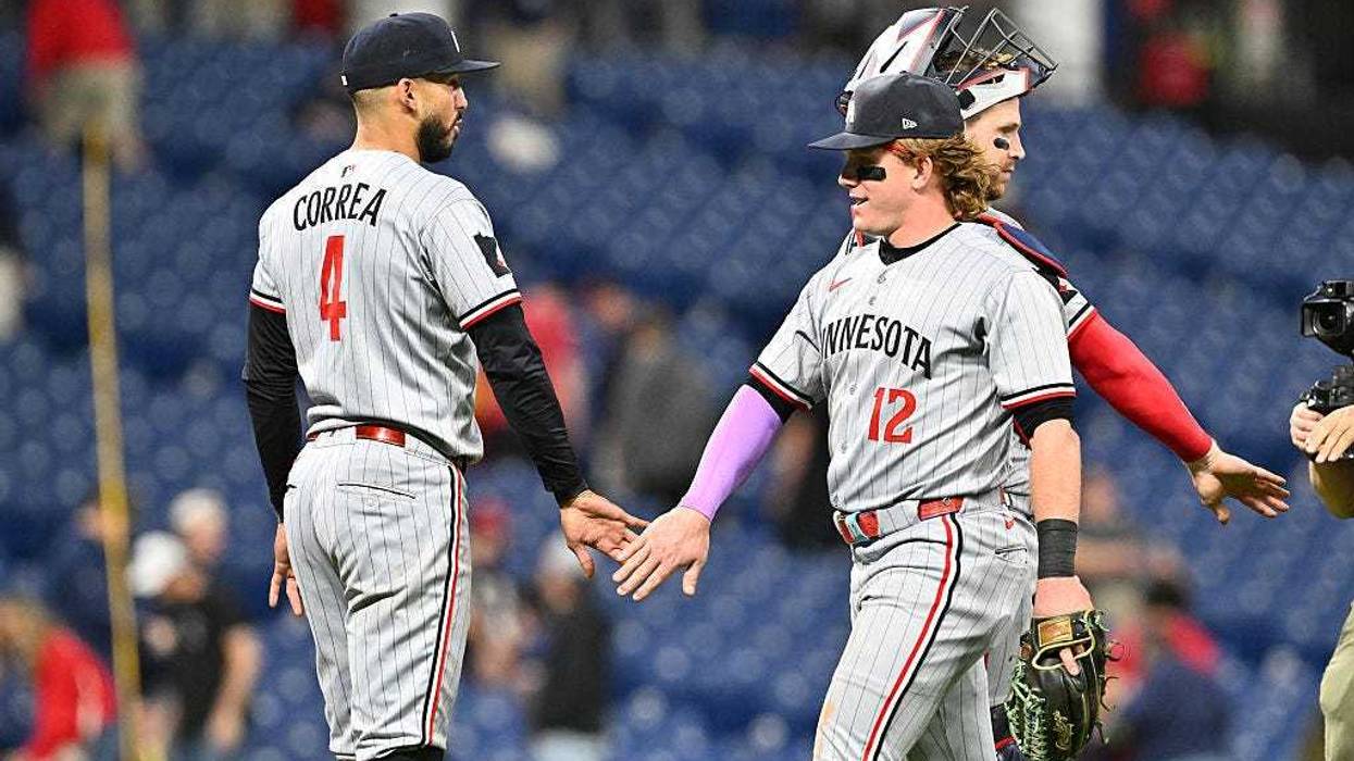 Carlos Correa #4 of the Minnesota Twins celebrates with teammate Harrison Bader #12 after the game against the Cleveland Guardians at Progressive Field on April 28, 2025 in Cleveland, Ohio. The Twins defeated the Guardians 11-1.