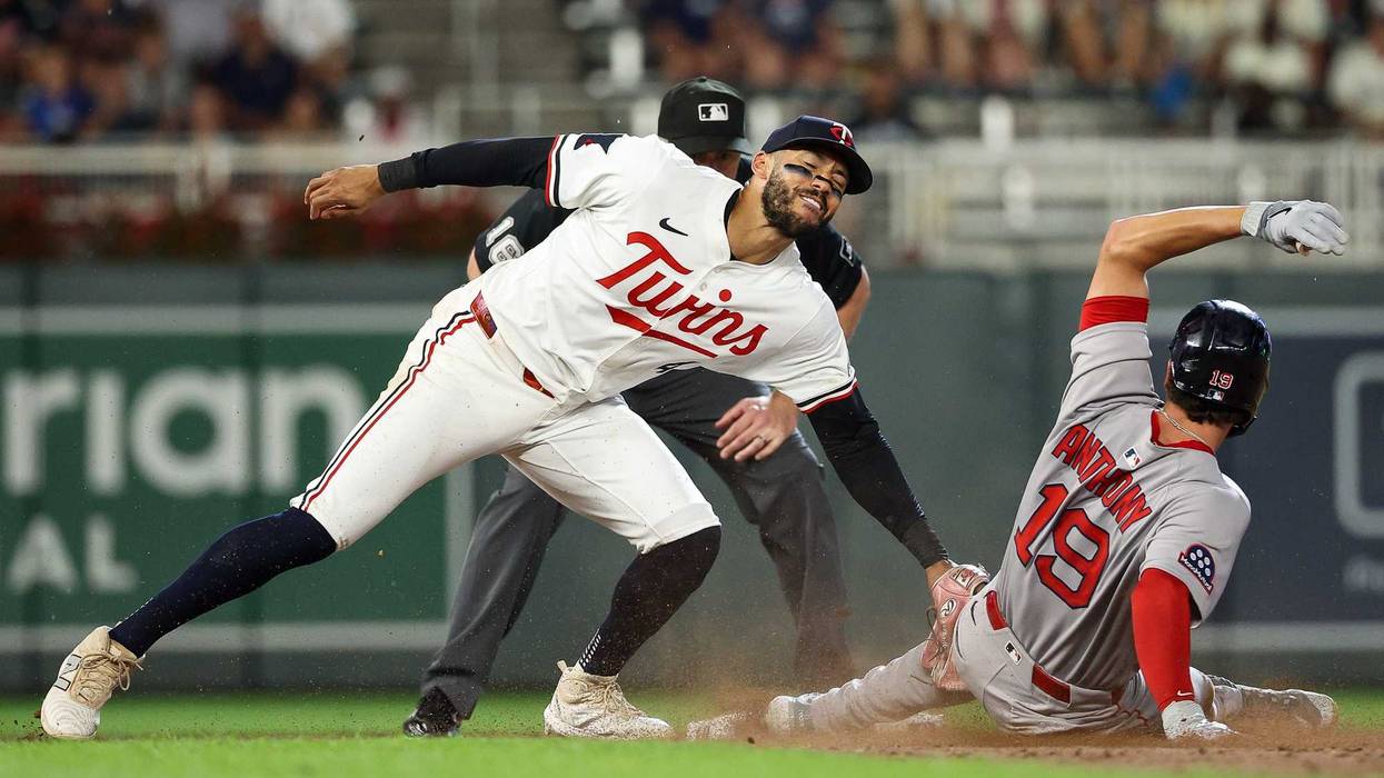 Carlos Correa #4 of the Minnesota Twins tags out Roman Anthony #19 of the Boston Red Sox at second base on a steal attempt during the ninth inning at Target Field on July 28, 2025 in Minneapolis, Minnesota.