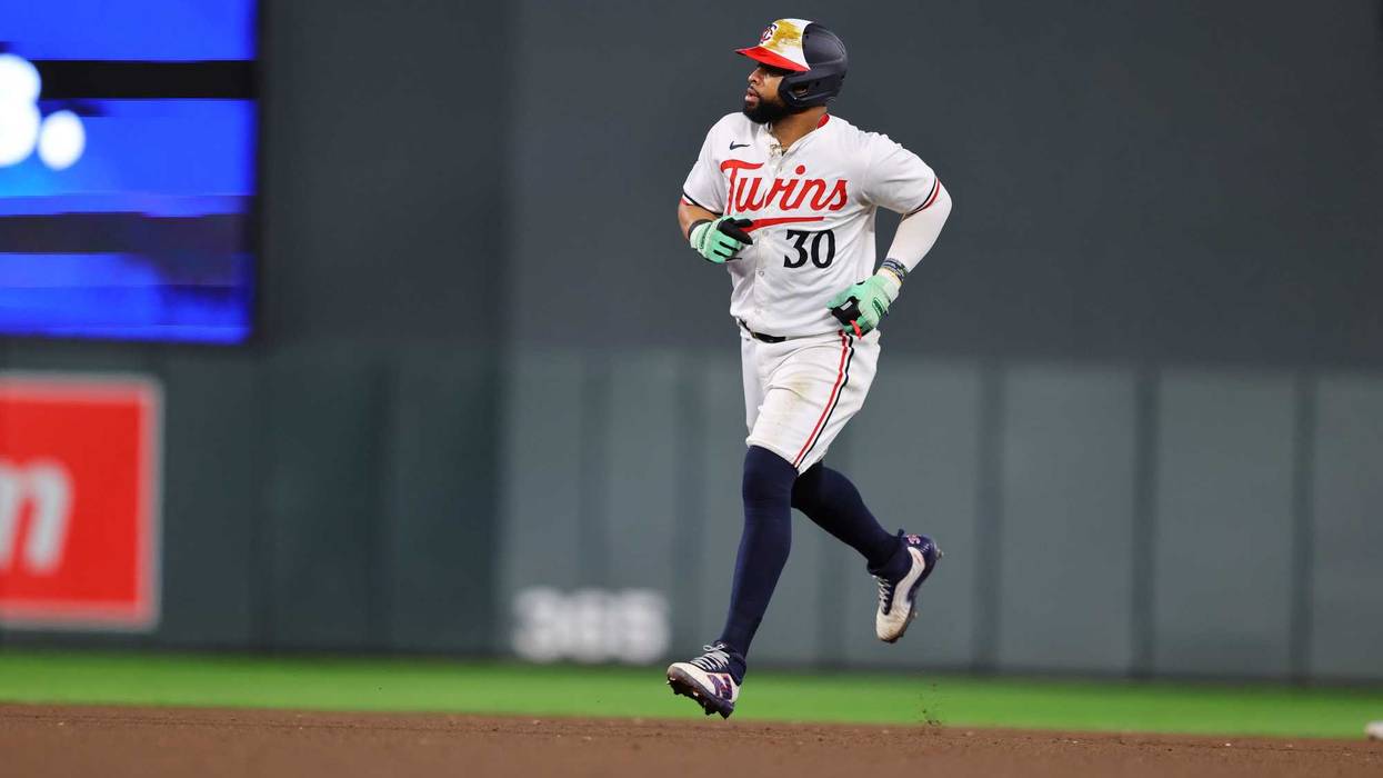 Carlos Santana #30 of the Minnesota Twins rounds the bases at Target Field. Santana signed a free agent contract to return to the Twins' AL Central rivals in Cleveland.