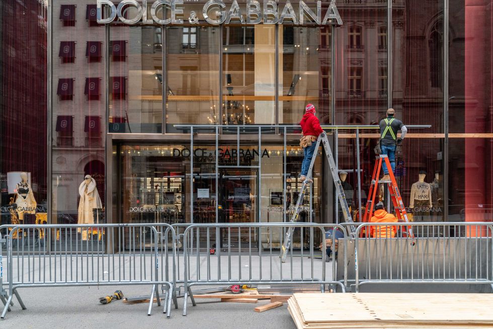 Carpenters board up a Dolce & Gabbana store located on 5th Avenue on November 1, 2020 in New York City.