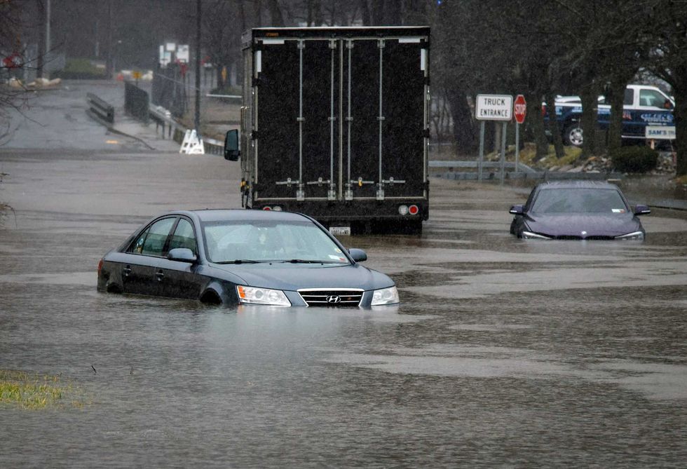 Cars are seen abandoned in floodwater in Elmsford on Dec. 18, 2023