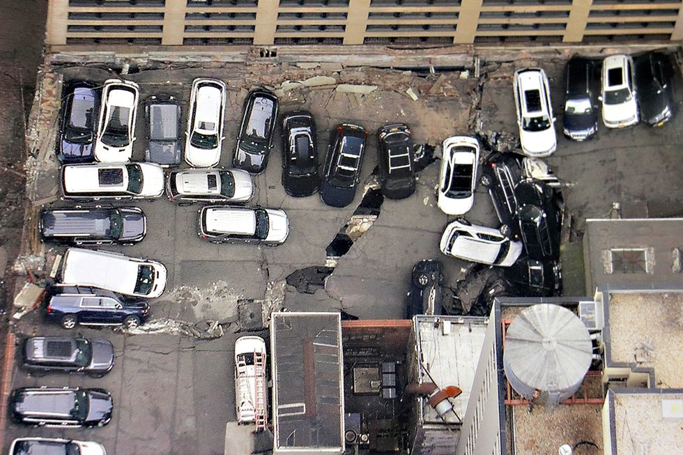Cars are seen at the partial collapse of a parking garage in the Financial District of New York on April 19, 2023