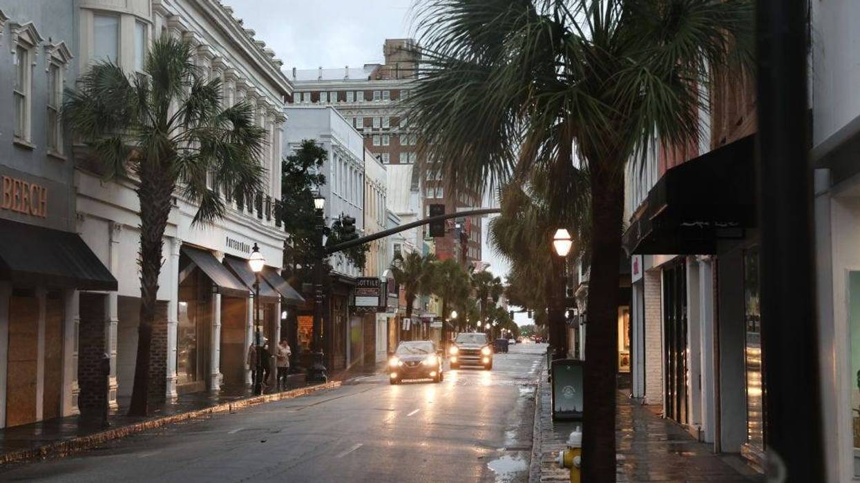 Cars drive through a nearly-deserted historic district as the city prepares for Hurricane Ian to make landfall on September 30, 2022 in Charleston, South Carolina.