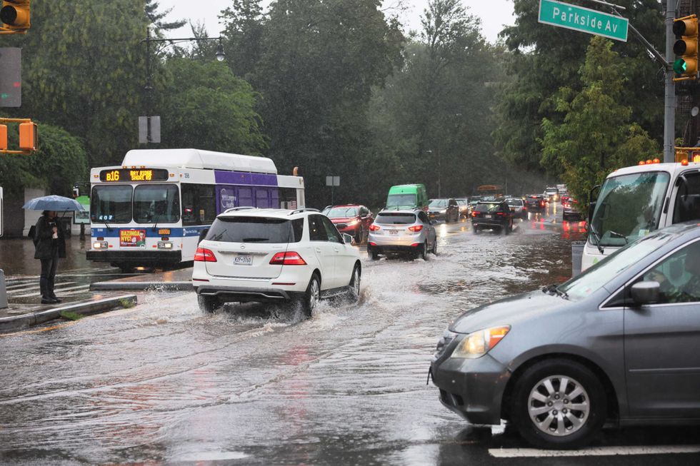 Cars drive through slight flooding on Ocean Avenue amid heavy rain on September 29, 2023 in the Flatbush neighborhood of Brooklyn