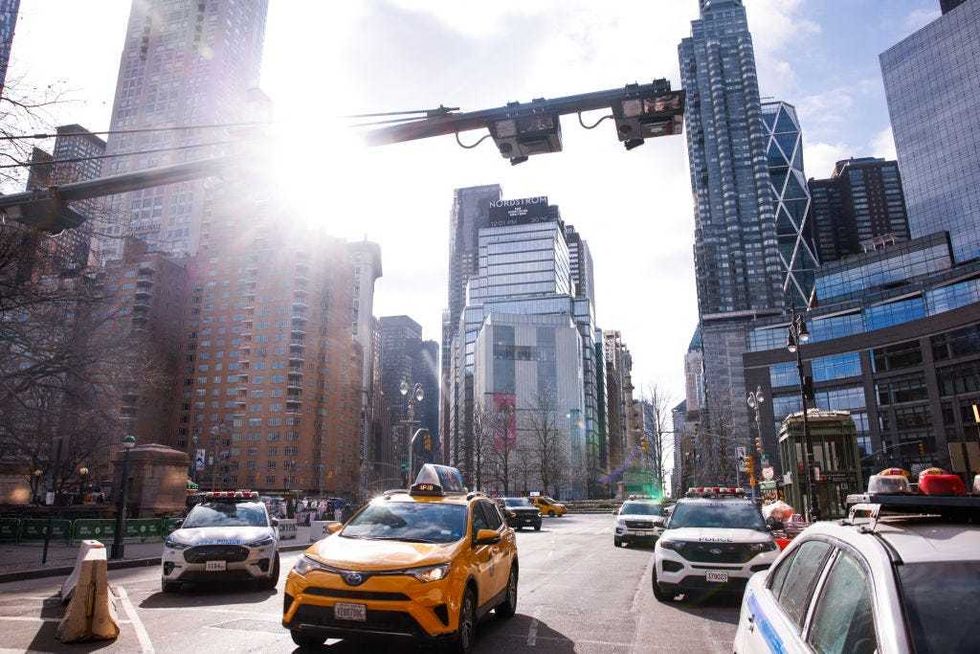 Cars drive under E-ZPass readers and license plate-scanning cameras on Columbus Circle as congestion pricing takes effect in New York City on Jan. 5, 2024.