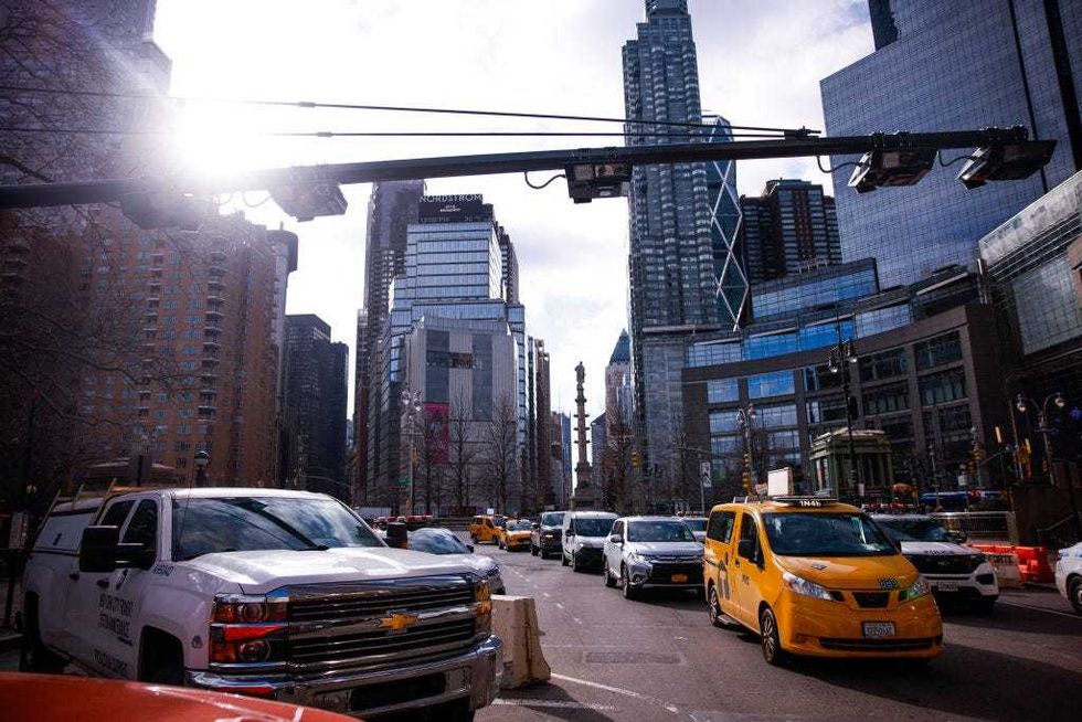 Cars drive under E-ZPass readers and license plate-scanning cameras on Columbus Circle as congestion pricing takes effect in New York City on Jan. 5, 2024.