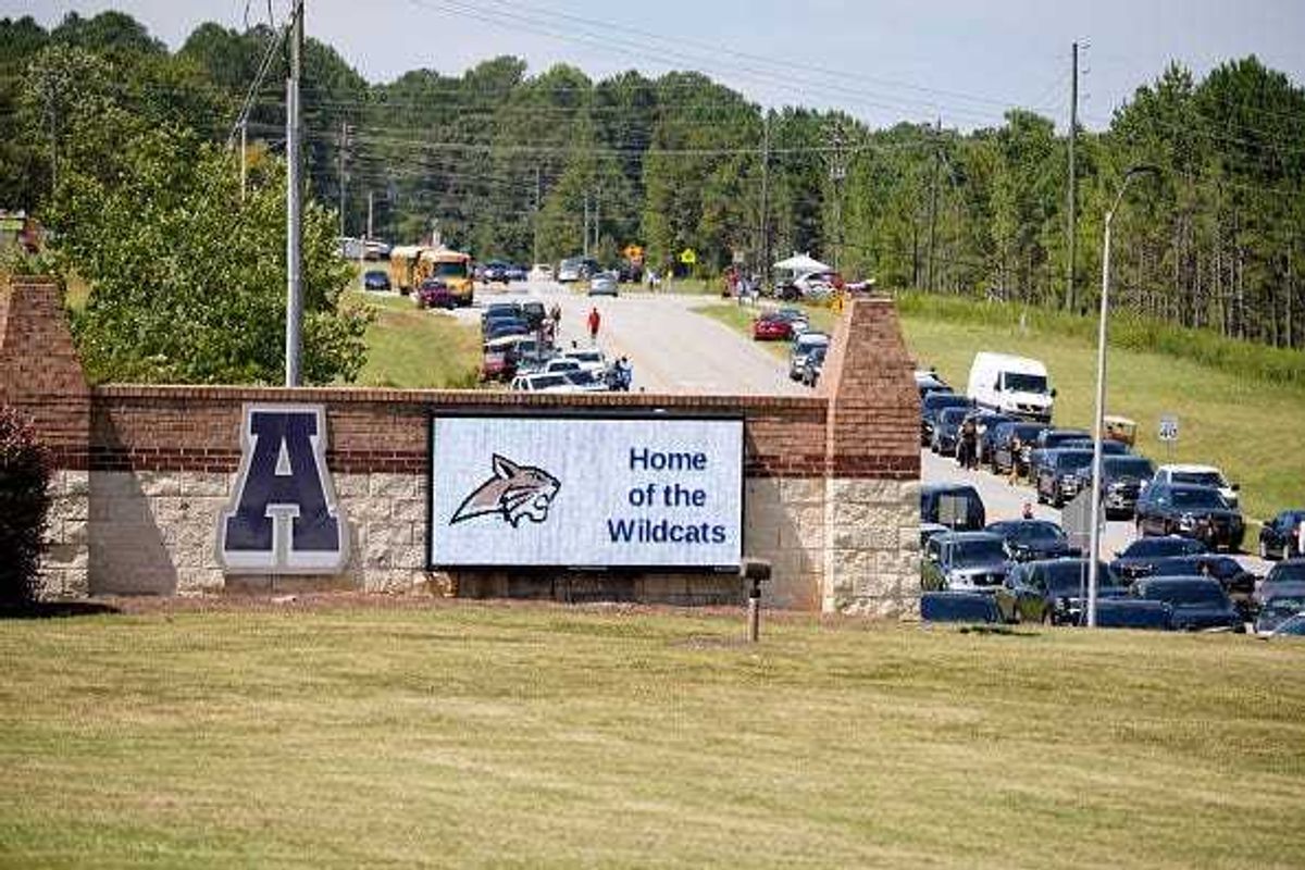 Cars line the road as parents arrive to meet students after a shooting at Apalachee High School on September 4, 2024 in Winder, Georgia.