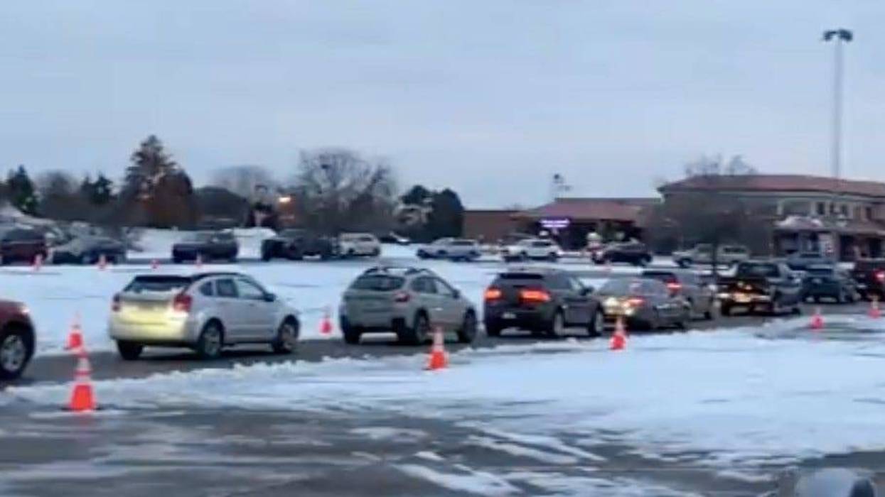 Cars lined up for a free PCR test in Sterling Heights