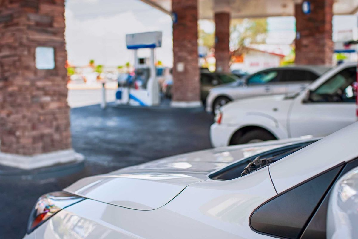 Cars parked at a gas station.