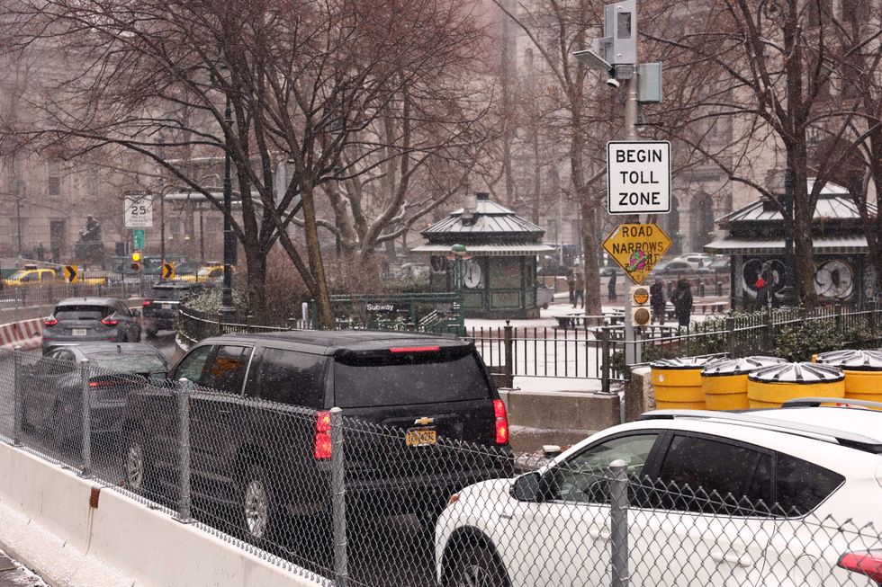 Cars pass a toll sign as they drive into Manhattan on January 6, 2025