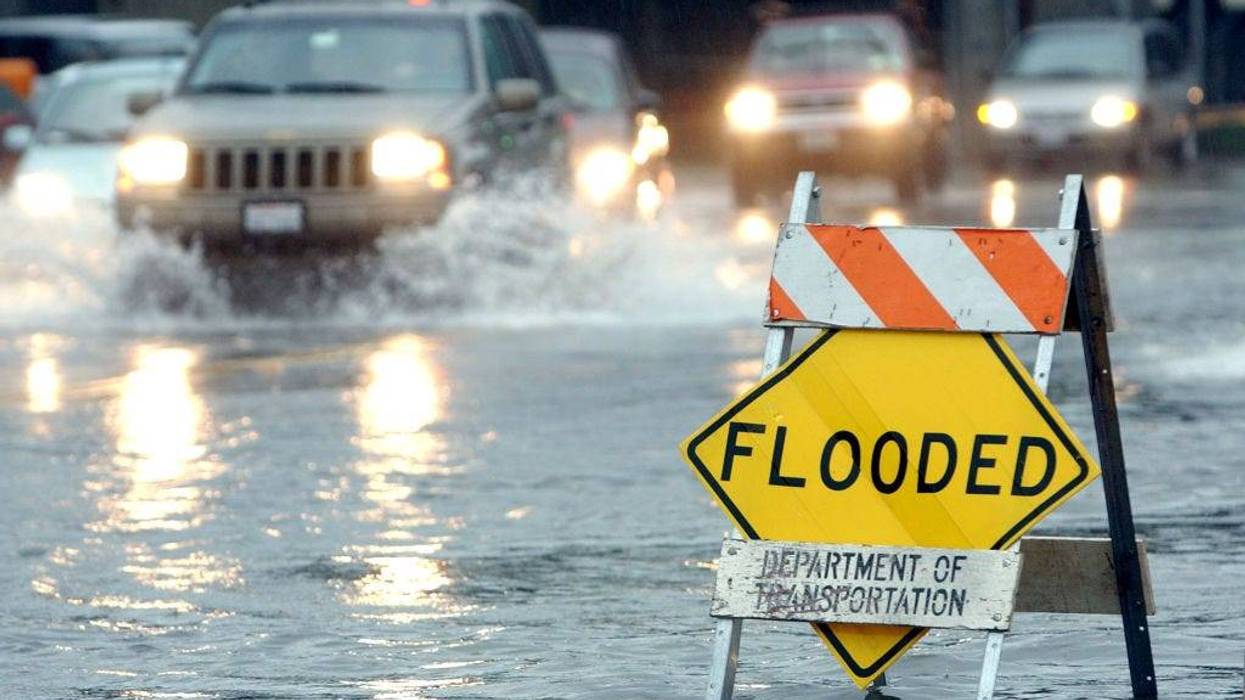 Cars pass through a flooded section of road December 19, 2002 in Mill Valley, California.